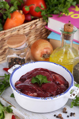 Raw liver in pan with spices and condiments