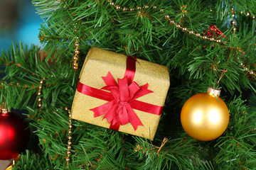 Gift on Christmas tree on room background