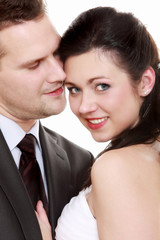 Portrait of happy bride and groom on white background
