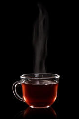 Glass cup of tea with vapor