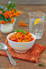 Pumpkin stew in a bowl on a wooden table