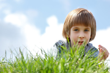 cute little boy laying on green grass spring nature outdoor