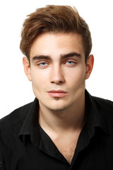 Fototapeta premium Handsome young man's portrait, sexy guy looking at camera over w