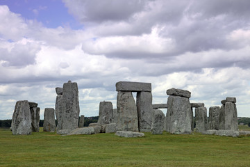 Stonehenge historic site on green grass under blue sky. Stonehen