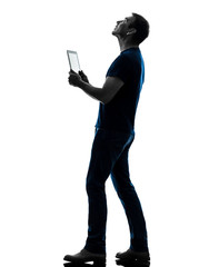 man holding digital tablet  looking up silhouette