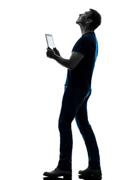 Man Holding Digital Tablet  Looking Up Silhouette