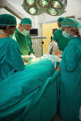 Patient being operated by a team of surgeon