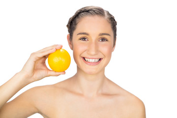 Smiling natural model holding orange