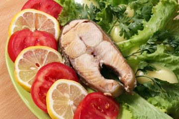 seafood salmon with lemon tomatoes and green salad