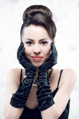 Retro portrait of a smiling beautiful woman in gloves