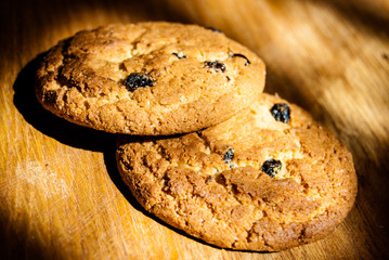 two oatmeal cookies on wood