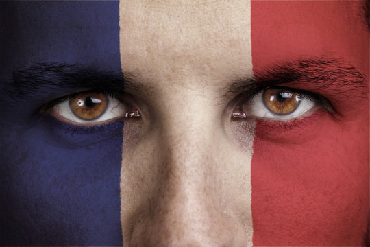 france, french flag painted on the face of young man