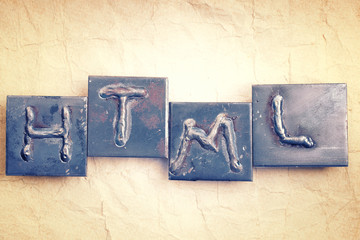 Abbreviation HTML made from metal letters on an old vintage pape