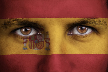spain, spanish flag painted on the face of young man