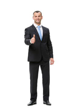 Full-length portrait of businessman who thumbs up
