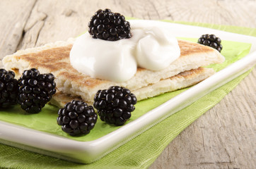 potato pancakes with sour cream and blackberries