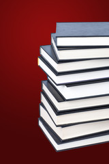 Stack of hardcover books on a color background