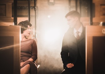 Beautiful vintage style couple inside retro train coach