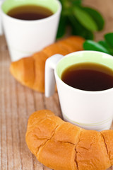two cups of tea and fresh croissants