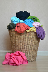 Pile of colorful shirts in a wicker basket