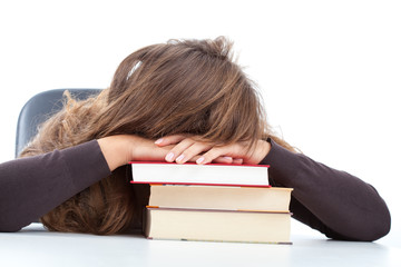 Pupil sleeping on her books