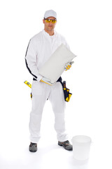 worker in white overalls holding a bucket trowel tools package