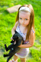 child holding kitten