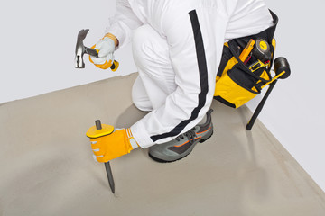 Worker with chisel check concrete base