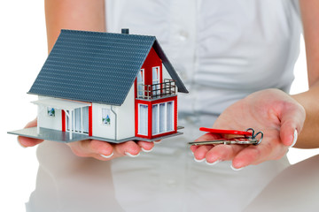 Immobilienmaklerin mit Haus und Schlüßel