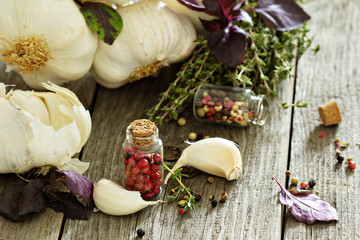 Garlic, herbs and spices on a wooden table