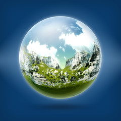 A glass transparent ball with mountains inside it. 