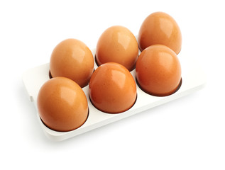 six eggs in a tray on white background