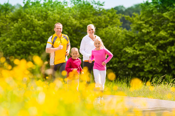 Family jogging in the meadow for fitness