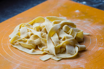 Crude homemade Italian pasta tagliatelli, freshly prepared