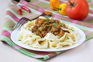 Italian pasta tagliatelle with meat sauce and vegetables, tasty