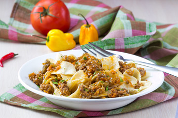 Italian pasta tagliatelle with meat sauce and vegetables, tasty