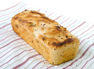 One loaf of bread on tablecloth