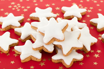 Star shaped cinnamon biscuits on red background
