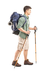 Full length portrait of a hiker with backpack and hiking poles w