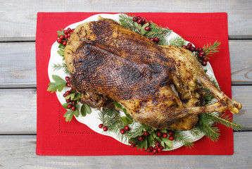 Baked goose on wooden table. Popular christmas dish