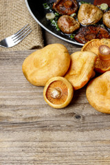 Saffron milk cap mushrooms on wooden table. Copy space