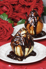 Pears with chocolate. Stunning red roses in the background