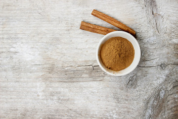 Bowl of cinnamon on wooden table