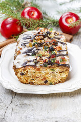 Fruitcake with dried fruits and nuts in christmas setting