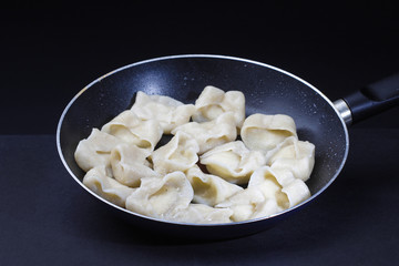 Traditional polish dumplings isolated in black background