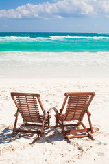 Beach wooden chairs for vacations and relax on tropical white