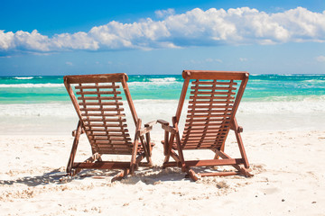 Beach wooden chairs for vacations and relax on tropical white