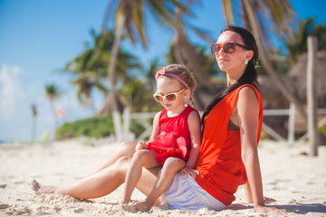 Fototapeta premium Little girl with her young mom relaxing on carribean beach