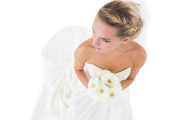 Obraz na płótnie Canvas High angle view of blonde bride holding a bouquet