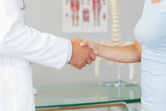 Close up of doctor shaking hands with patient